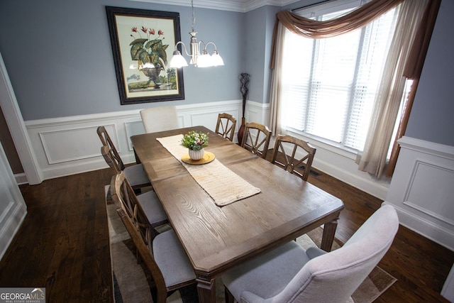 6147 Pritchett Dr, Powder Springs, GA 30127 - dining room with a chandelier, wainscoting, dark wood-type flooring, a decorative wall, and crown molding