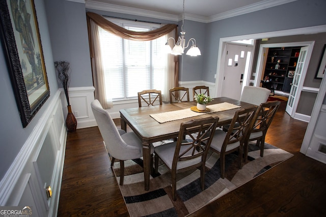 6147 Pritchett Dr, Powder Springs, GA 30127 - dining space featuring dark wood-style floors, wainscoting, crown molding, and a chandelier