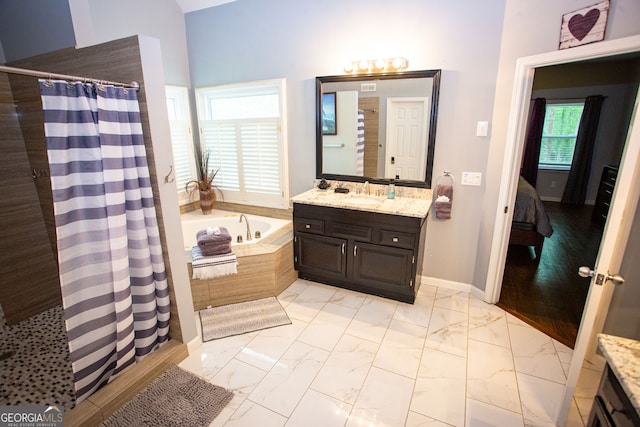 6147 Pritchett Dr, Powder Springs, GA 30127 - bathroom with marble finish floors, vanity, a garden tub, and connected bathroom