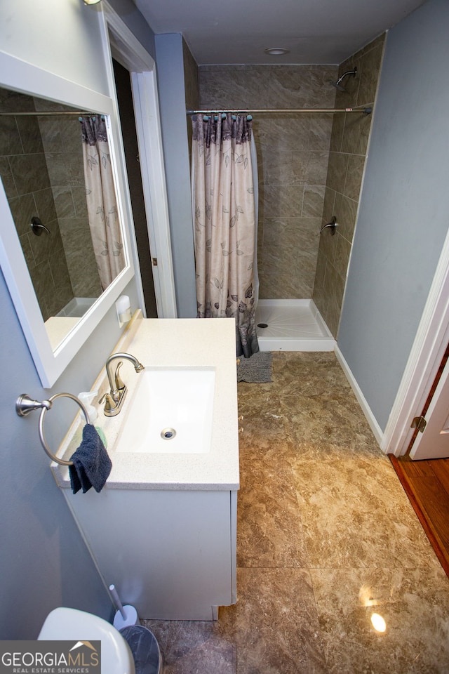 6147 Pritchett Dr, Powder Springs, GA 30127 - full bath with a tile shower, vanity, and toilet