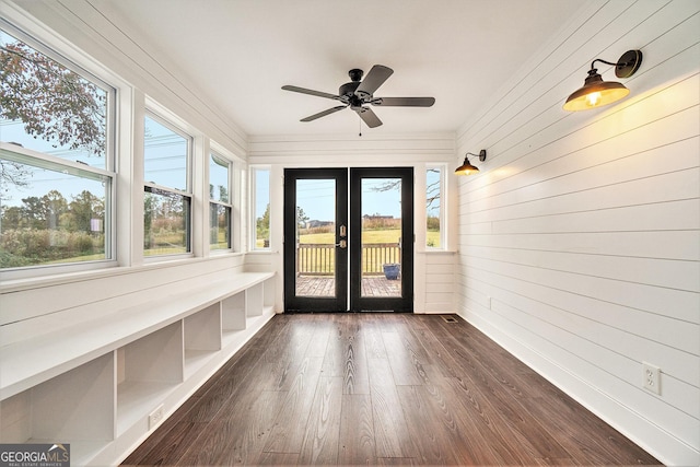 unfurnished sunroom featuring wood finished floors, a wealth of natural light, and french doors