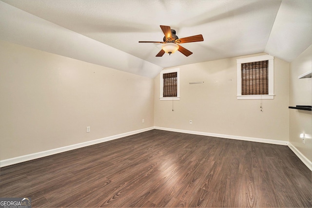 additional living space featuring ceiling fan, lofted ceiling, dark wood-style flooring, and baseboards