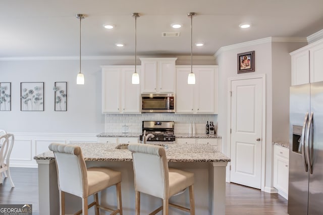kitchen featuring white cabinets, dark wood-style floors, backsplash, crown molding, and appliances with stainless steel finishes