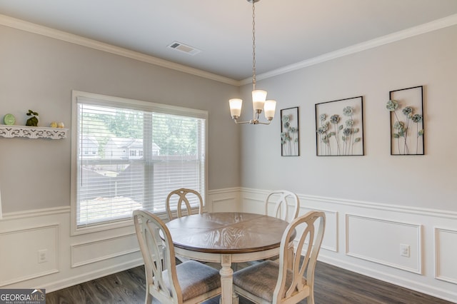dining area with a wainscoted wall, dark wood-style floors, and a notable chandelier