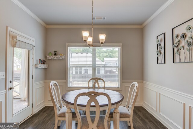 1380 Chester Way, Hoschton, GA 30548 - dining room with dark wood-style floors, healthy amount of natural light, a wainscoted wall, a chandelier, and ornamental molding