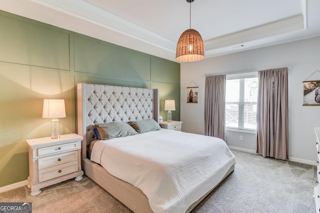 bedroom with a raised ceiling, visible vents, ornamental molding, light carpet, and baseboards