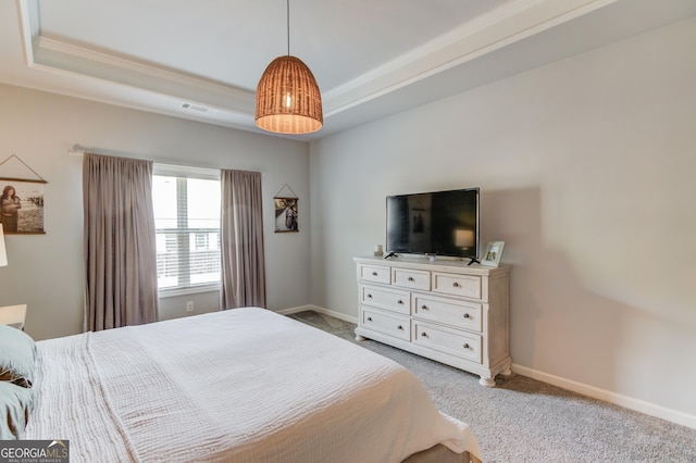bedroom featuring a raised ceiling, baseboards, visible vents, light colored carpet, and ornamental molding