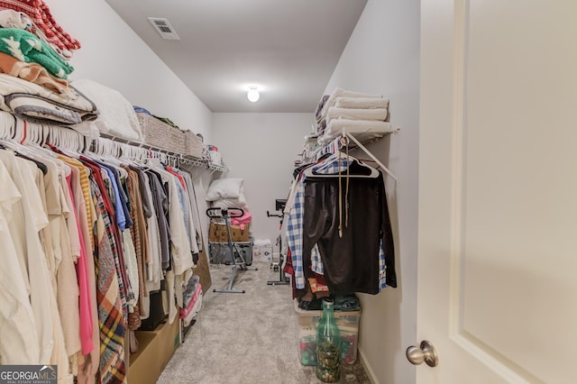 walk in closet with visible vents and carpet flooring