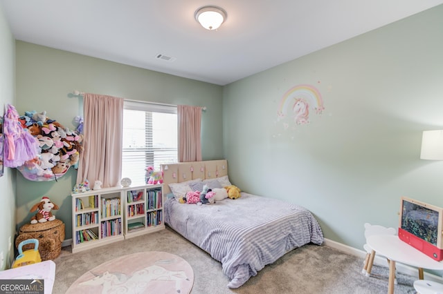 carpeted bedroom featuring visible vents and baseboards