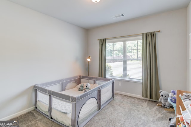 carpeted bedroom featuring visible vents and baseboards