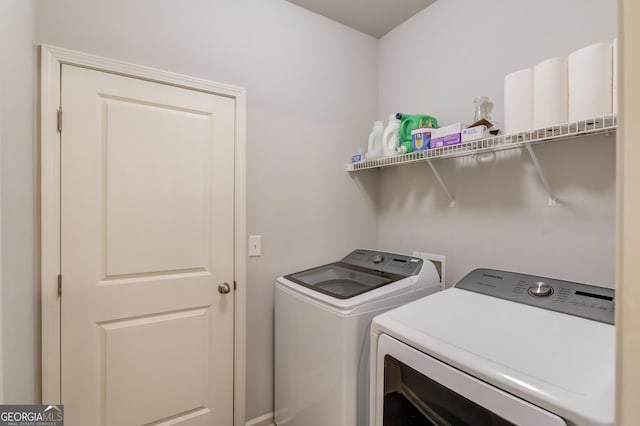 laundry area with washing machine and clothes dryer and laundry area
