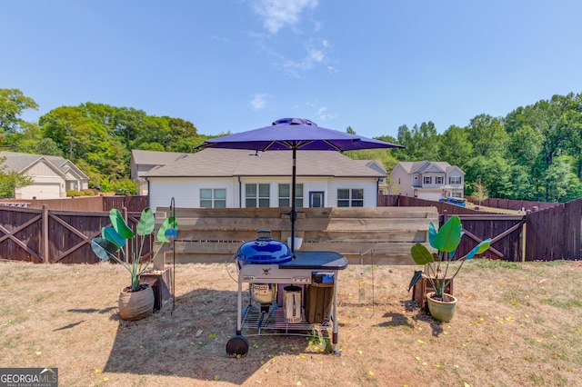 rear view of house with a fenced backyard