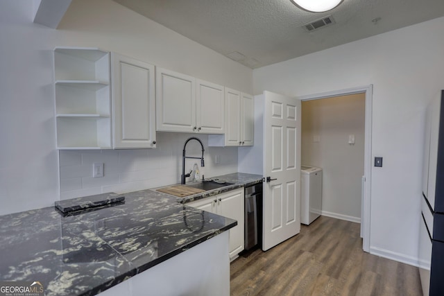 kitchen featuring a sink, dishwasher, white cabinetry, dark wood-type flooring, and visible vents