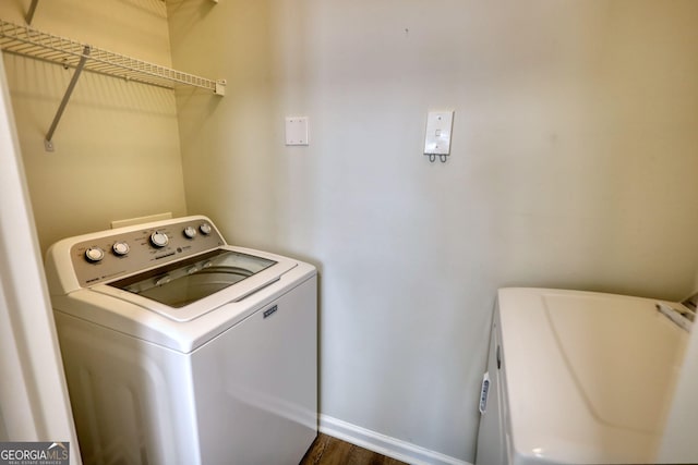 laundry area featuring baseboards, laundry area, and separate washer and dryer