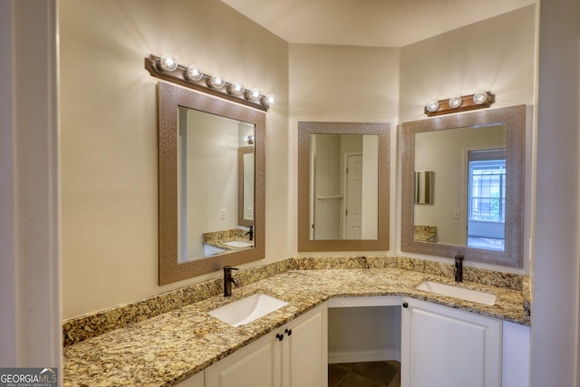 full bathroom featuring double vanity, tile patterned floors, and a sink