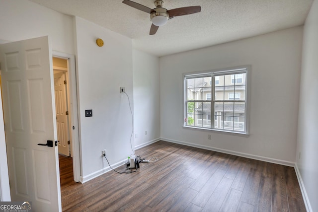 unfurnished room featuring ceiling fan, baseboards, and wood finished floors