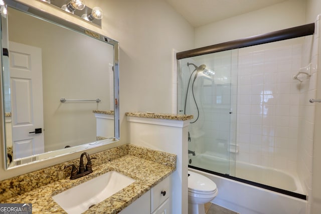 full bathroom with vanity, toilet, and bath / shower combo with glass door