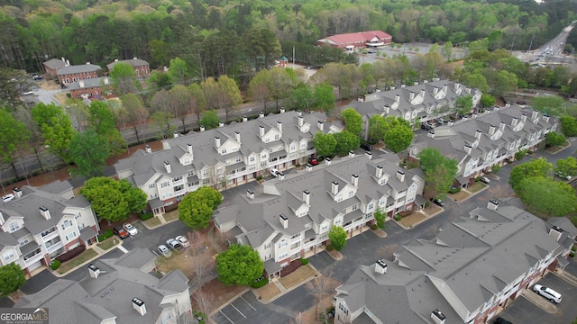 birds eye view of property with a residential view and a wooded view