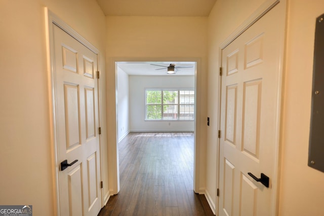 hall with dark wood finished floors and baseboards
