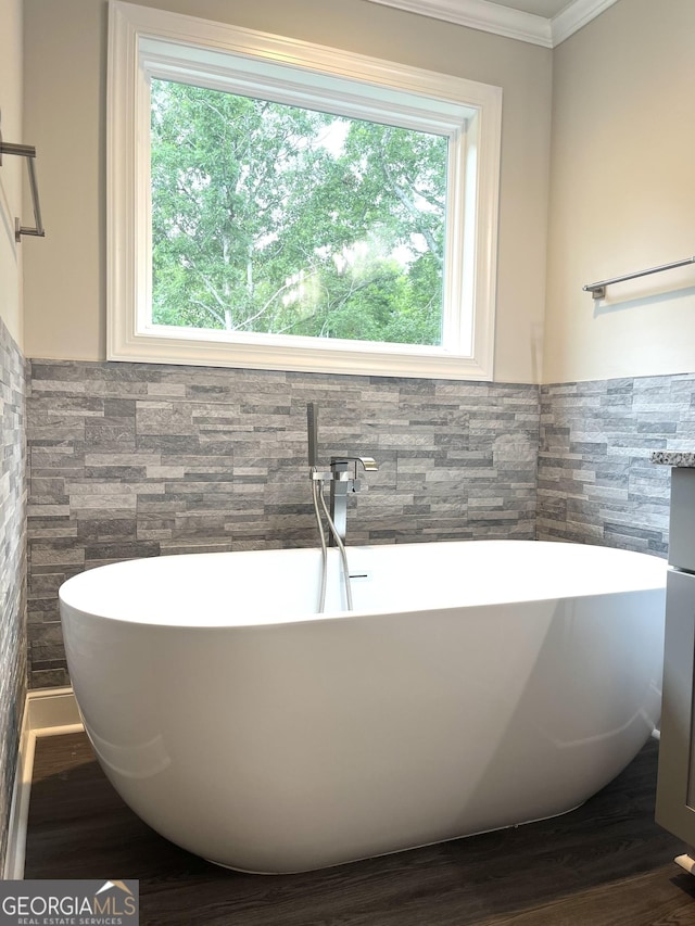3 Highlander Trl SW, Rome, GA 30165 - bathroom featuring tile walls, healthy amount of natural light, a freestanding bath, ornamental molding, and wood finished floors