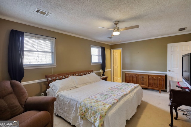 bedroom with ornamental molding, visible vents, and light carpet