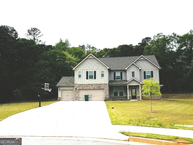 165 Jodi Pl, Locust Grove, GA 30248 - craftsman house with stone siding, concrete driveway, an attached garage, board and batten siding, and a front yard