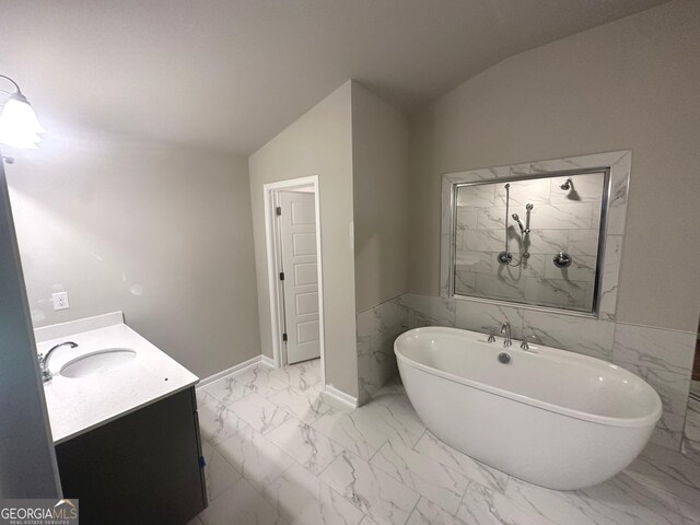 165 Jodi Pl, Locust Grove, GA 30248 - bathroom with a soaking tub, vaulted ceiling, marble finish floor, a shower, and vanity