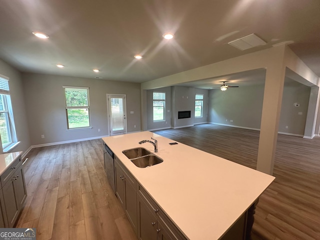 165 Jodi Pl, Locust Grove, GA 30248 - kitchen with light countertops, wood finished floors, a sink, baseboards, and open floor plan