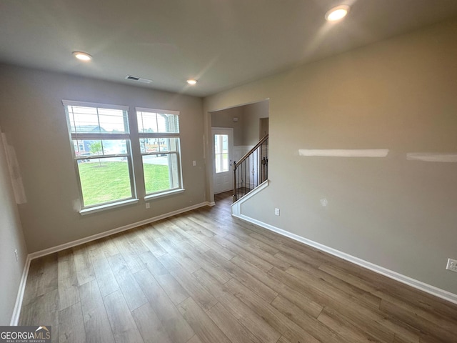 165 Jodi Pl, Locust Grove, GA 30248 - unfurnished living room with stairway, wood finished floors, baseboards, visible vents, and recessed lighting