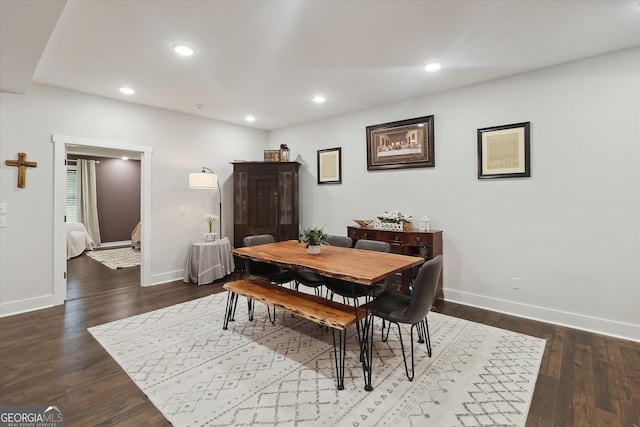 dining room featuring dark wood finished floors, baseboards, and recessed lighting