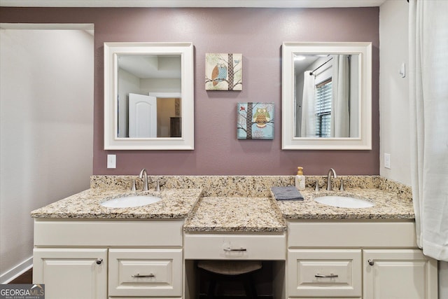 bathroom featuring a sink and double vanity