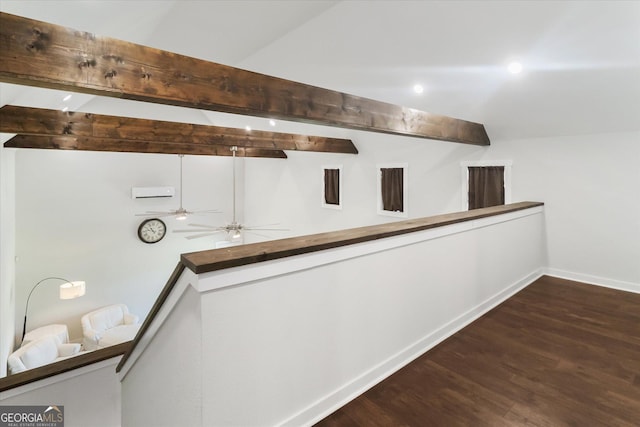 hallway with wood finished floors, beam ceiling, and baseboards
