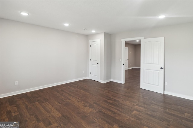 basement with recessed lighting, baseboards, and dark wood-style floors