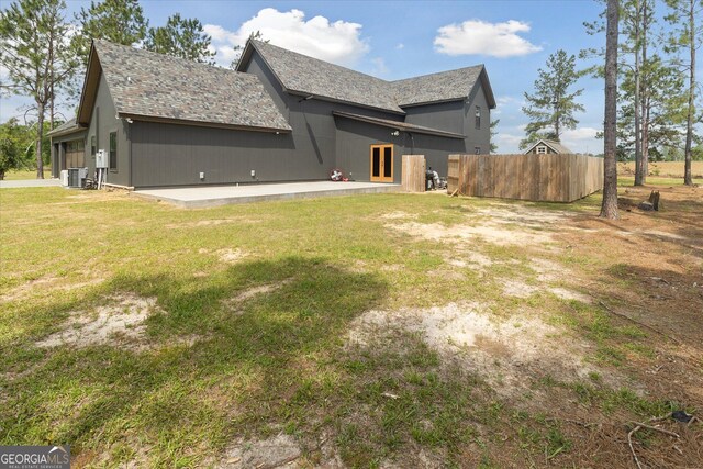 back of house with french doors, central air condition unit, fence, a patio area, and a yard