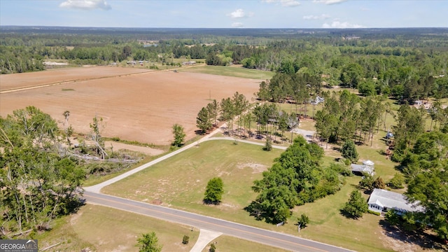 birds eye view of property with a forest view
