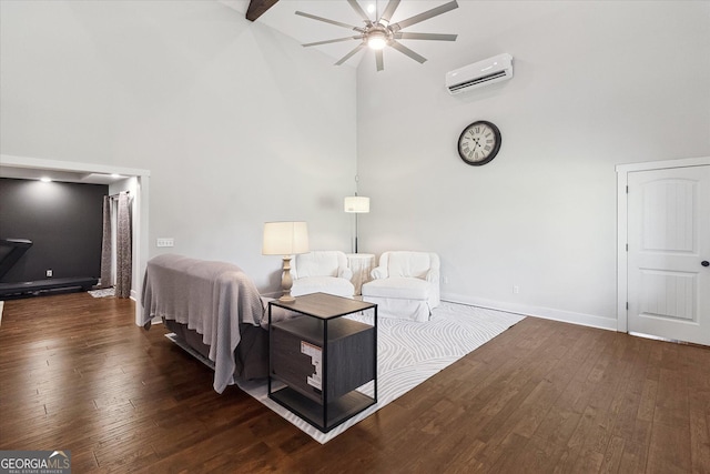 bedroom featuring hardwood / wood-style floors, baseboards, a towering ceiling, and an AC wall unit