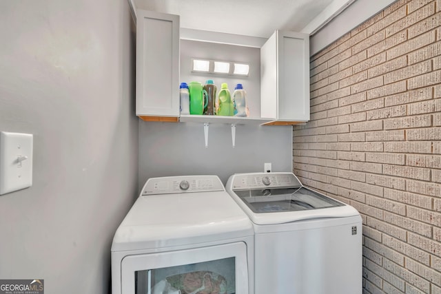 laundry room featuring washing machine and clothes dryer and cabinet space
