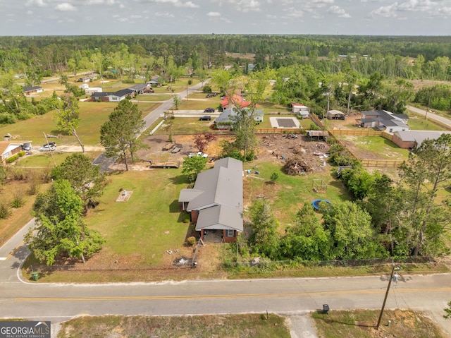 birds eye view of property featuring a forest view