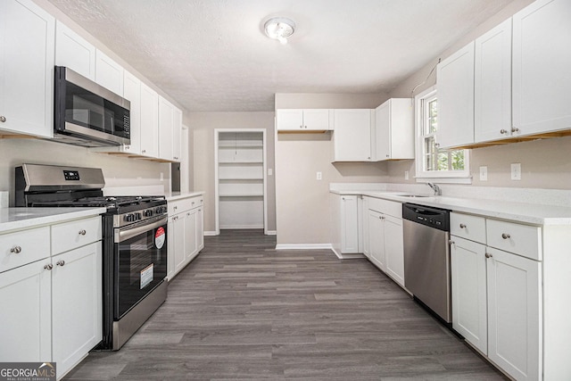 20 King Pl, Stockbridge, GA 30281 - kitchen featuring white cabinetry, wood finished floors, stainless steel appliances, and a sink