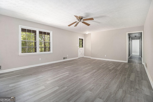 20 King Pl, Stockbridge, GA 30281 - spare room with wood finished floors, visible vents, a ceiling fan, baseboards, and a textured ceiling