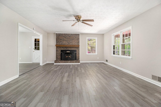 20 King Pl, Stockbridge, GA 30281 - unfurnished living room with a ceiling fan, wood finished floors, a textured ceiling, baseboards, and visible vents