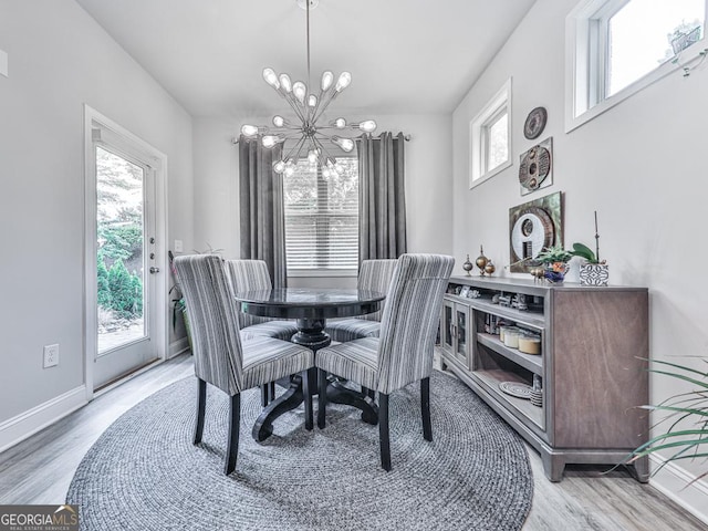 130 Maple Creek Way, Woodstock, GA 30188 - dining room featuring light wood-type flooring, a notable chandelier, and a healthy amount of sunlight