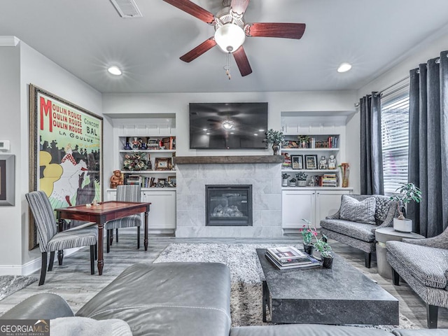 130 Maple Creek Way, Woodstock, GA 30188 - living room featuring ceiling fan, a tiled fireplace, recessed lighting, wood finished floors, and visible vents
