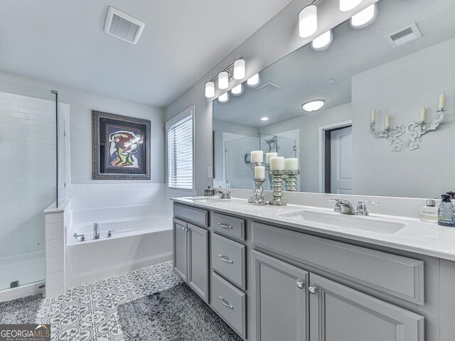 130 Maple Creek Way, Woodstock, GA 30188 - bathroom featuring a sink, a shower stall, a garden tub, and visible vents