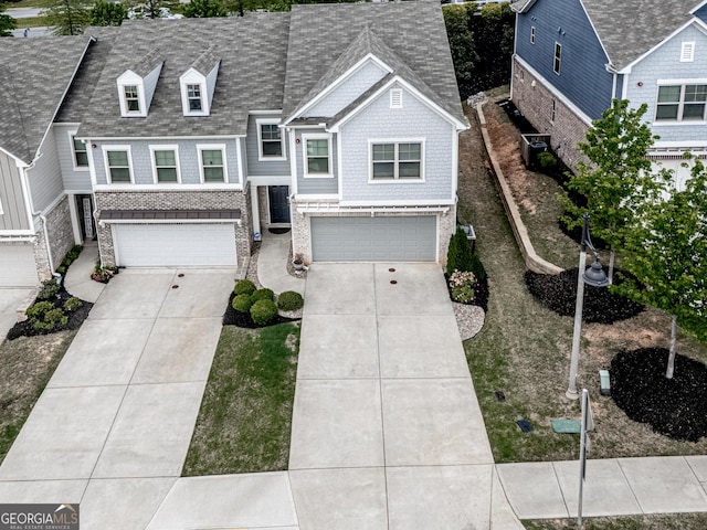 130 Maple Creek Way, Woodstock, GA 30188 - view of front facade with central AC unit, an attached garage, and concrete driveway
