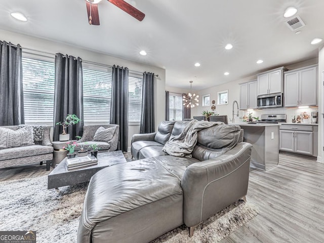 130 Maple Creek Way, Woodstock, GA 30188 - living area with recessed lighting, visible vents, a healthy amount of sunlight, and ceiling fan with notable chandelier