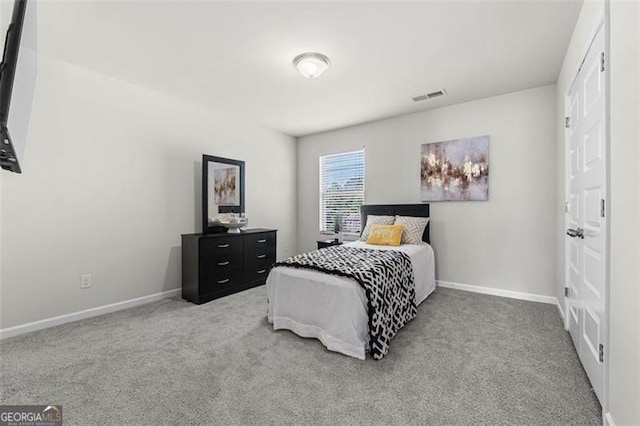 bedroom with visible vents, carpet flooring, and baseboards