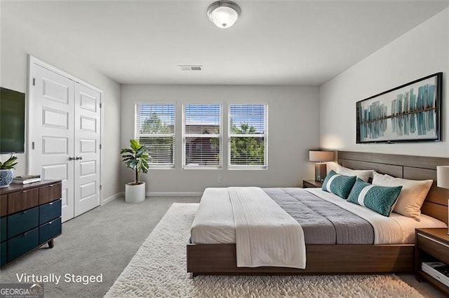 carpeted bedroom with baseboards and visible vents