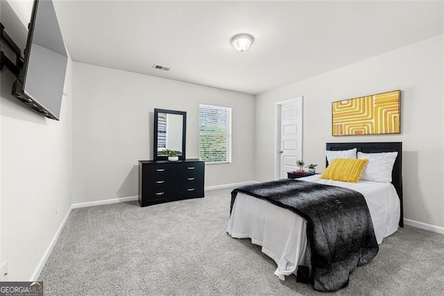 carpeted bedroom with baseboards and visible vents