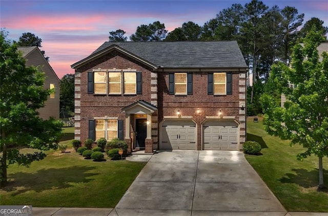 view of front of home with brick siding, a yard, an attached garage, and concrete driveway